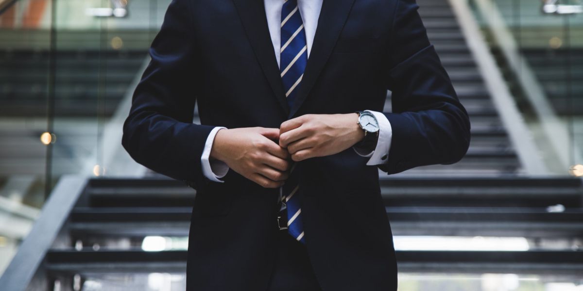 man in a suit prepares to meet new employer